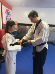 Student receiving their black belt
